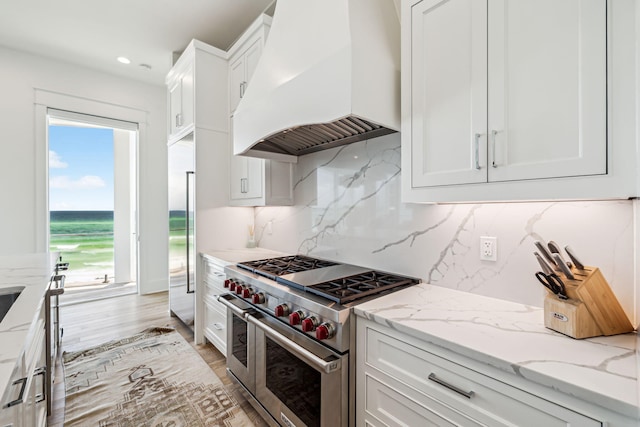 323 Pompano St, Inlet Beach, FL 32461 - kitchen featuring custom exhaust hood, high quality appliances, white cabinetry, decorative backsplash, and light stone counters