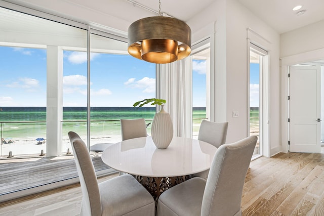 323 Pompano St, Inlet Beach, FL 32461 - dining area featuring light wood finished floors, view of water and beach, plenty of natural light, and recessed lighting