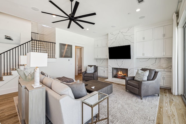 323 Pompano St, Inlet Beach, FL 32461 - living area with light wood-type flooring, a fireplace, a ceiling fan, stairway, and recessed lighting
