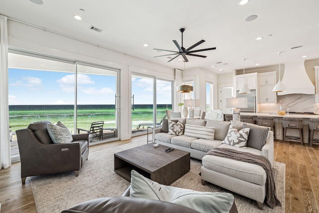 323 Pompano St, Inlet Beach, FL 32461 - living room with ceiling fan, a water view, light wood-style floors, and recessed lighting