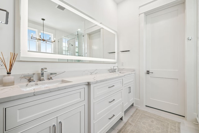 323 Pompano St, Inlet Beach, FL 32461 - bathroom featuring double vanity, a stall shower, and a chandelier