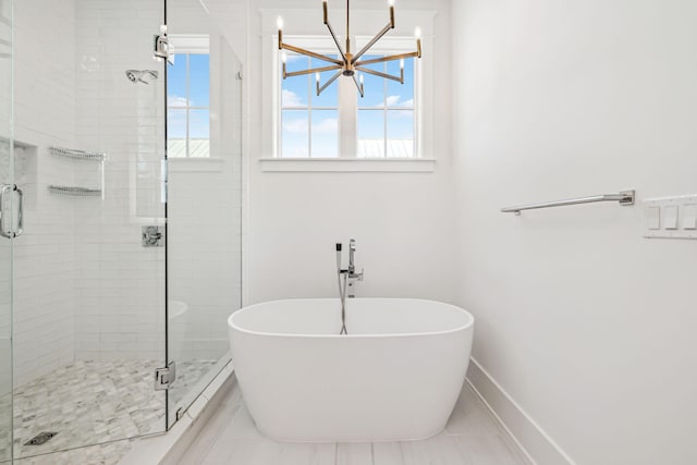 323 Pompano St, Inlet Beach, FL 32461 - full bath with a chandelier, a soaking tub, a shower stall, baseboards, and tile patterned floors