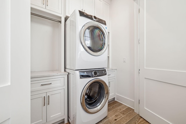 323 Pompano St, Inlet Beach, FL 32461 - laundry room with cabinet space, estacked washer and dryer, and light wood-style floors