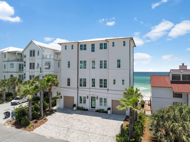 323 Pompano St, Inlet Beach, FL 32461 - view of property featuring decorative driveway, a garage, and a water view
