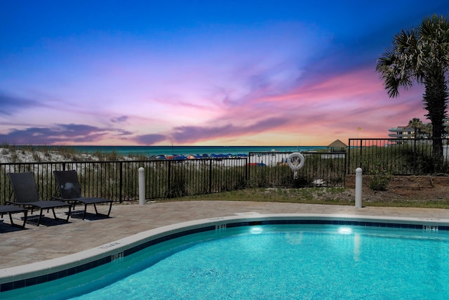 134 Norwood Dr Unit Ph1, Miramar Beach, FL 32550 - pool at dusk featuring a community pool, a water view, and a patio area