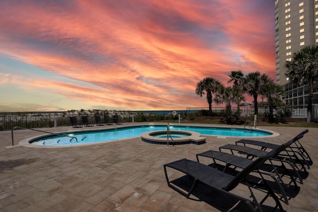 134 Norwood Dr Unit Ph1, Miramar Beach, FL 32550 - pool at dusk featuring a patio and a pool with connected hot tub