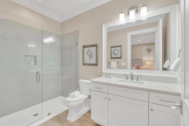 134 Norwood Dr Unit Ph1, Miramar Beach, FL 32550 - ensuite bathroom featuring toilet, vanity, a stall shower, ornamental molding, and wood finished floors