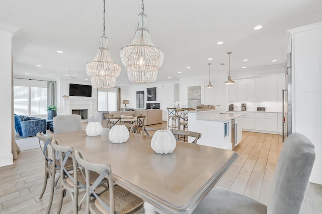 134 Norwood Dr Unit Ph1, Miramar Beach, FL 32550 - dining space featuring a fireplace, a chandelier, recessed lighting, and light wood finished floors
