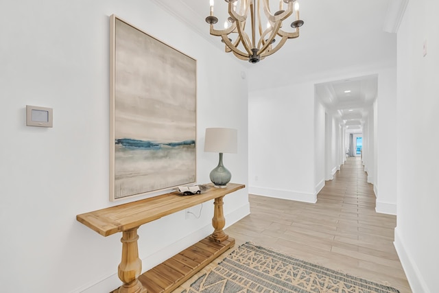 134 Norwood Dr Unit Ph1, Miramar Beach, FL 32550 - hallway with baseboards, a chandelier, wood finished floors, and ornamental molding