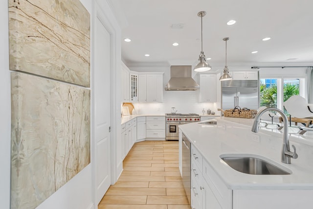 134 Norwood Dr Unit Ph1, Miramar Beach, FL 32550 - kitchen featuring high quality appliances, wall chimney exhaust hood, a sink, recessed lighting, and light countertops