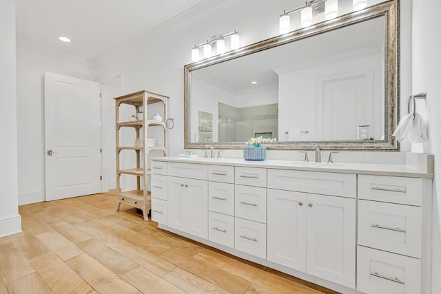 134 Norwood Dr Unit Ph1, Miramar Beach, FL 32550 - bathroom with double vanity, a stall shower, crown molding, wood finished floors, and recessed lighting