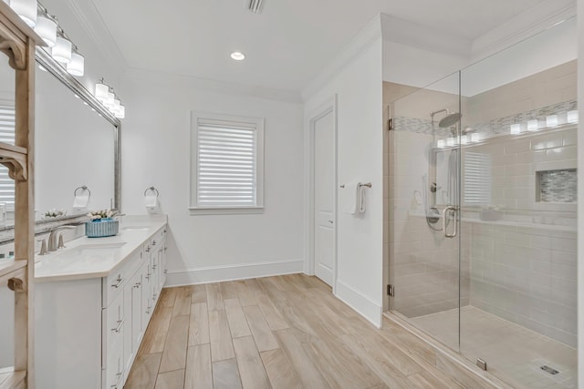 134 Norwood Dr Unit Ph1, Miramar Beach, FL 32550 - bathroom with double vanity, a stall shower, ornamental molding, wood finished floors, and baseboards