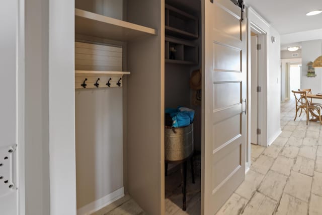 9800 Grand Sandestin Blvd Unit 5602/5604, Sandestin, FL 32550 - mudroom with a barn door and baseboards