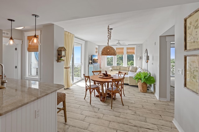 9800 Grand Sandestin Blvd Unit 5602/5604, Sandestin, FL 32550 - dining space with ceiling fan, light wood-type flooring, and baseboards