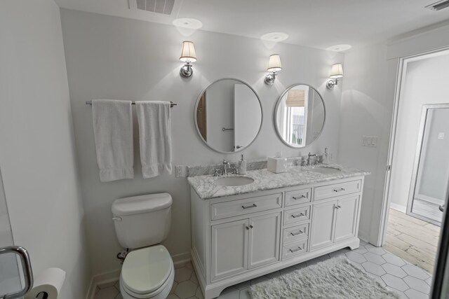 9800 Grand Sandestin Blvd Unit 5602/5604, Sandestin, FL 32550 - bathroom with double vanity, toilet, baseboards, and tile patterned floors
