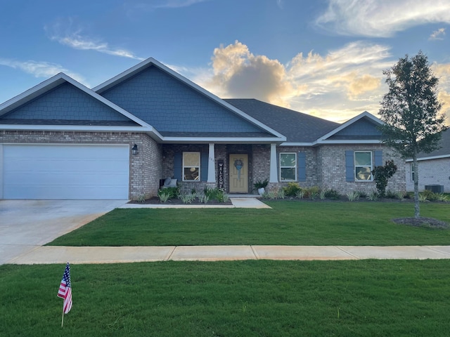 106 E Sky Way, Freeport, FL 32439 - craftsman-style home with a front yard, an attached garage, driveway, brick siding, and central AC unit