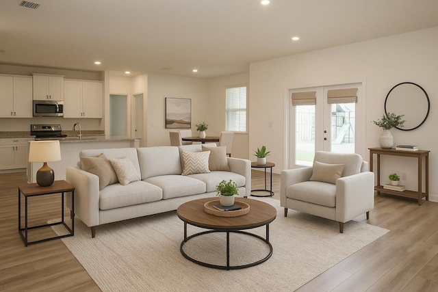 106 E Sky Way, Freeport, FL 32439 - living room with light wood-style floors, recessed lighting, french doors, and baseboards