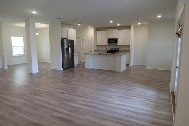 106 E Sky Way, Freeport, FL 32439 - kitchen featuring stainless steel appliances, open floor plan, white cabinets, light wood finished floors, and recessed lighting