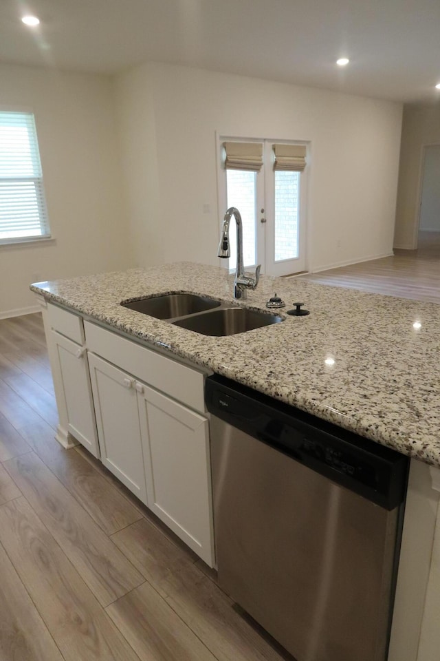 106 E Sky Way, Freeport, FL 32439 - kitchen with dishwasher, a sink, light wood-style floors, white cabinetry, and light stone counters