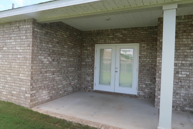 106 E Sky Way, Freeport, FL 32439 - view of exterior entry with french doors, brick siding, and a patio