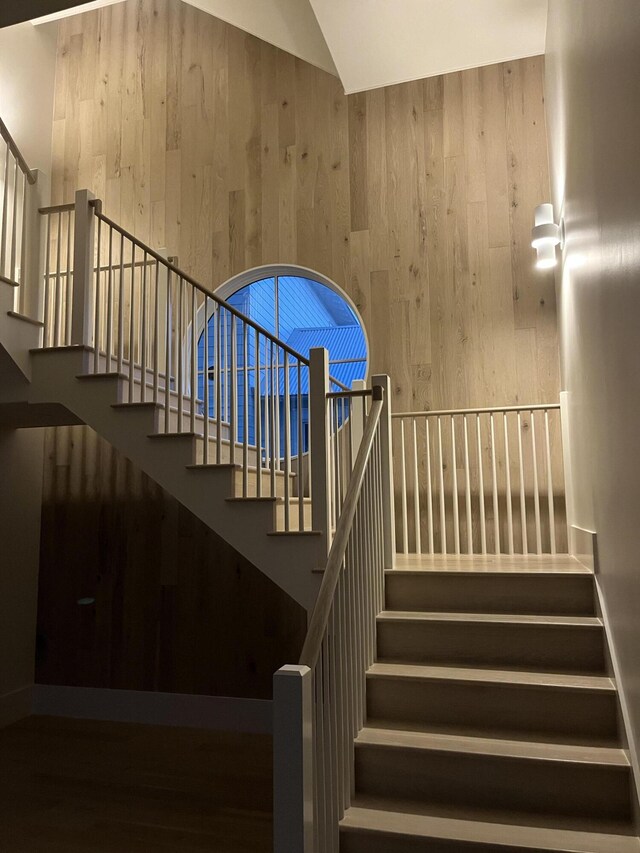 181 Climbing Rose Way, Santa Rosa Beach, FL 32459 - stairway featuring wood walls, vaulted ceiling, and wood finished floors
