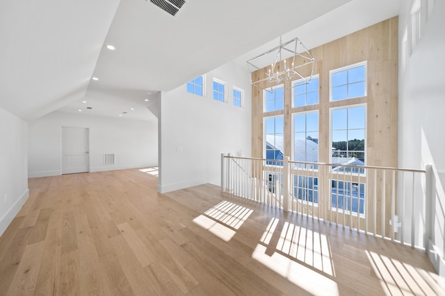 181 Climbing Rose Way, Santa Rosa Beach, FL 32459 - interior space featuring a chandelier, wood finished floors, baseboards, a high ceiling, and recessed lighting