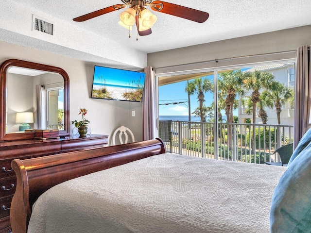 2606 Scenic Gulf Dr Unit 3208, Miramar Beach, FL 32550 - bedroom with access to outside, a textured ceiling, and a ceiling fan