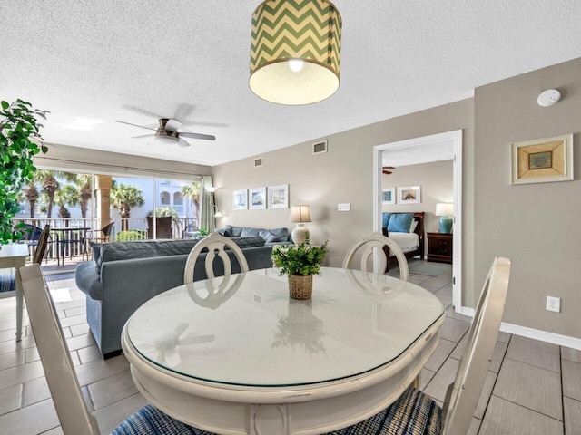 2606 Scenic Gulf Dr Unit 3208, Miramar Beach, FL 32550 - dining space featuring a ceiling fan, a textured ceiling, and light tile patterned flooring