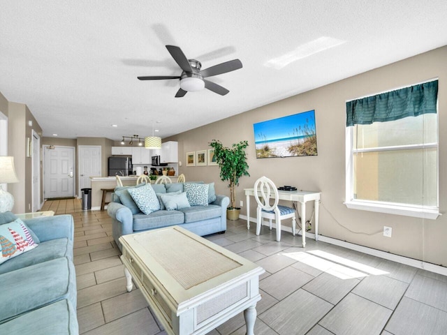 2606 Scenic Gulf Dr Unit 3208, Miramar Beach, FL 32550 - living room with a ceiling fan and a textured ceiling