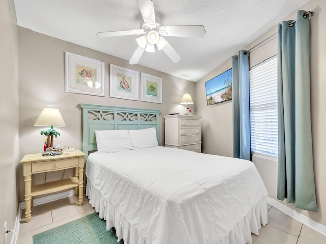 2606 Scenic Gulf Dr Unit 3208, Miramar Beach, FL 32550 - bedroom with light tile patterned floors, ceiling fan, baseboards, and a textured ceiling