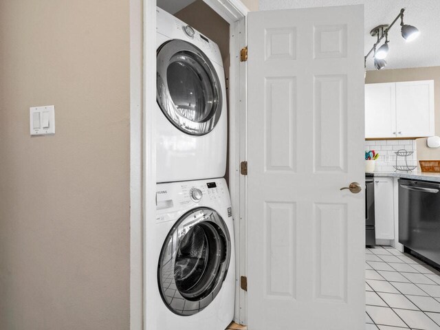 2606 Scenic Gulf Dr Unit 3208, Miramar Beach, FL 32550 - laundry room featuring stacked washing machine and dryer and light tile patterned floors