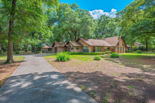 1131 Stanley Ln, Baker, FL 32531 - view of front facade with asphalt driveway and brick siding