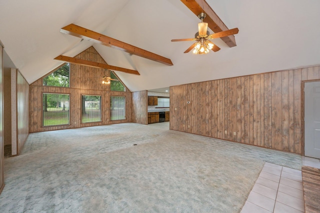 1131 Stanley Ln, Baker, FL 32531 - unfurnished living room with beamed ceiling, wooden walls, high vaulted ceiling, ceiling fan, and carpet