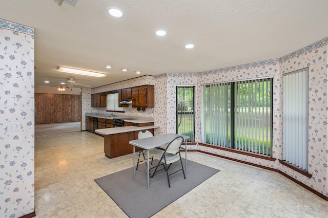 1131 Stanley Ln, Baker, FL 32531 - dining area featuring wallpapered walls, light floors, baseboards, a ceiling fan, and a textured ceiling