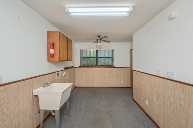 1131 Stanley Ln, Baker, FL 32531 - kitchen featuring wood walls, a wainscoted wall, ceiling fan, and carpet