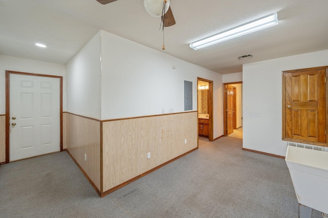 1131 Stanley Ln, Baker, FL 32531 - spare room featuring electric panel, light colored carpet, wainscoting, and ceiling fan