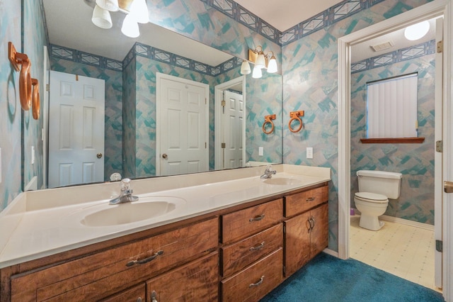 1131 Stanley Ln, Baker, FL 32531 - full bath featuring double vanity, wallpapered walls, toilet, and baseboards
