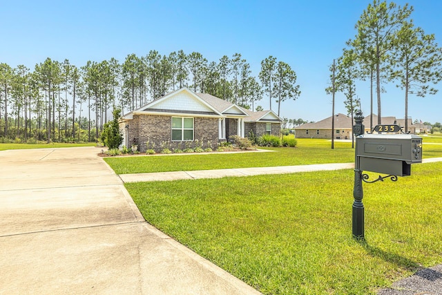 235 Coastal Breeze Dr, Freeport, FL 32439 - craftsman-style home featuring a front yard, driveway, and brick siding