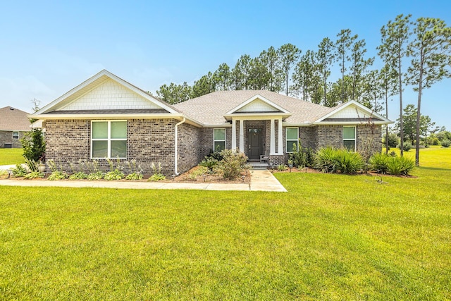 235 Coastal Breeze Dr, Freeport, FL 32439 - view of front of property featuring brick siding, a front lawn, and a shingled roof
