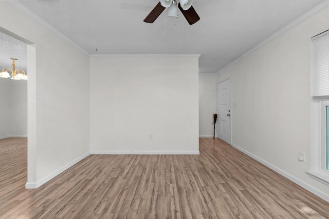 709 Russell Blvd, Fort Walton Beach, FL 32547 - unfurnished room with wood finished floors, a ceiling fan, a chandelier, crown molding, and baseboards