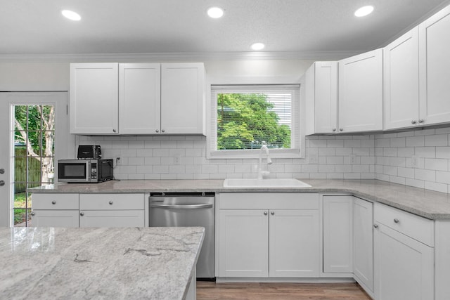 709 Russell Blvd, Fort Walton Beach, FL 32547 - kitchen featuring a sink, appliances with stainless steel finishes, crown molding, white cabinets, and light stone counters