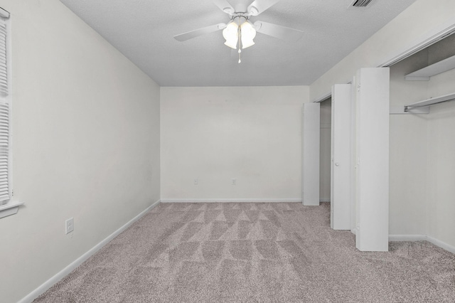 709 Russell Blvd, Fort Walton Beach, FL 32547 - unfurnished bedroom with carpet floors, baseboards, a ceiling fan, and a textured ceiling