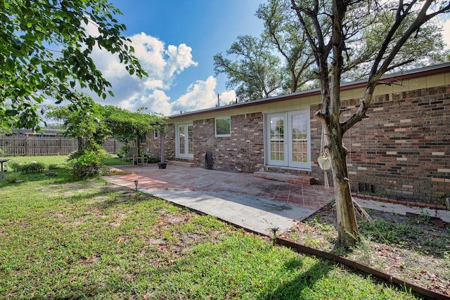 709 Russell Blvd, Fort Walton Beach, FL 32547 - rear view of property with french doors, a patio, and brick siding