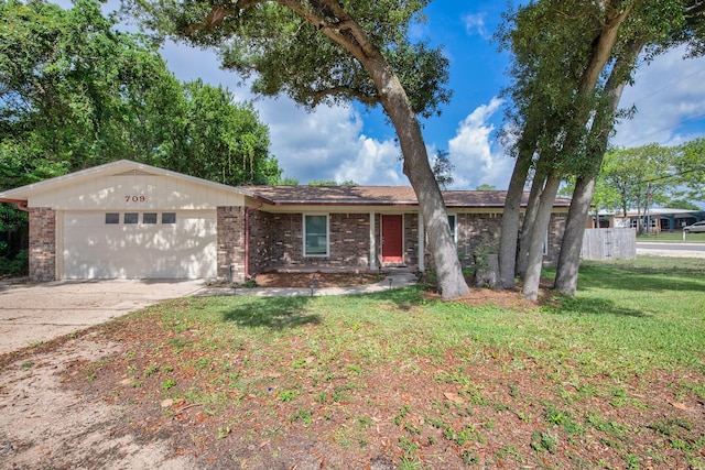 709 Russell Blvd, Fort Walton Beach, FL 32547 - single story home with an attached garage, brick siding, concrete driveway, and a front lawn
