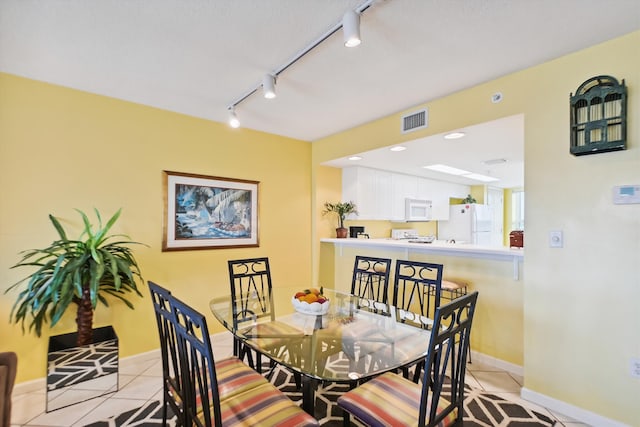 895 Santa Rosa Blvd Unit 707, Fort Walton Beach, FL 32548 - dining area featuring rail lighting, light tile patterned floors, and baseboards