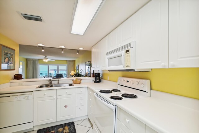 895 Santa Rosa Blvd Unit 707, Fort Walton Beach, FL 32548 - kitchen with white appliances, a sink, light tile patterned floors, white cabinets, and light countertops