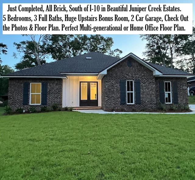 2675 Brodie Ln, Crestview, FL 32536 - view of front facade with a front lawn, brick siding, and board and batten siding