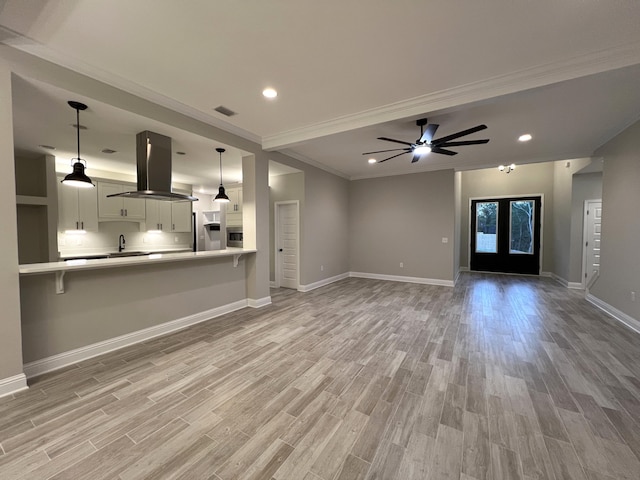 2675 Brodie Ln, Crestview, FL 32536 - unfurnished living room featuring a sink, light wood finished floors, ornamental molding, baseboards, and recessed lighting
