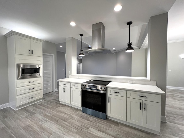 2675 Brodie Ln, Crestview, FL 32536 - kitchen featuring appliances with stainless steel finishes, island range hood, baseboards, light countertops, and hanging light fixtures