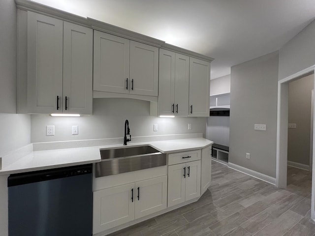 2675 Brodie Ln, Crestview, FL 32536 - kitchen with stainless steel dishwasher, a sink, light countertops, and light wood finished floors